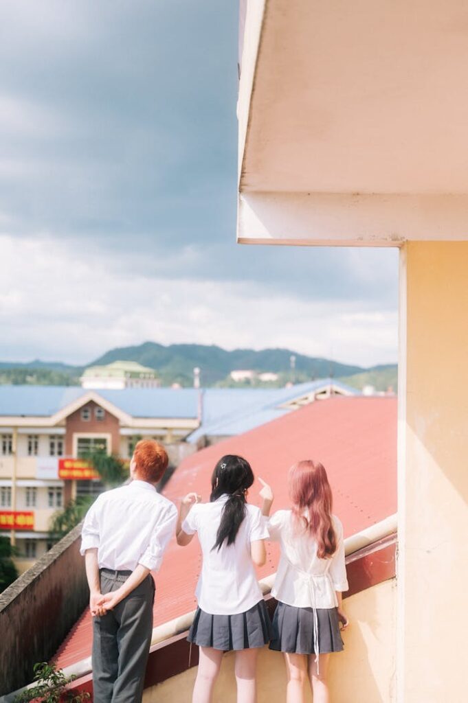 Three high school students enjoying the rooftop view in Lạng Sơn, Vietnam.